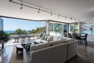 a living room with a white couch and a table at Picture Point Terraces in Noosa Heads