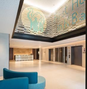 a large lobby with a large mosaic ceiling at Camlux Hotel in Hong Kong