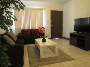 a living room with a couch and a coffee table at Pedro's Place in Tamuning