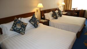 A bed or beds in a room at The Kimberley Hotel