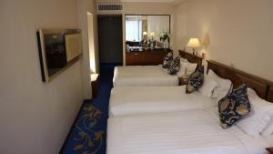 A bed or beds in a room at The Kimberley Hotel
