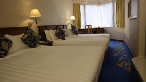 A bed or beds in a room at The Kimberley Hotel