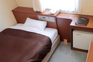 Postel nebo postele na pokoji v ubytování Utazu Grand Hotel