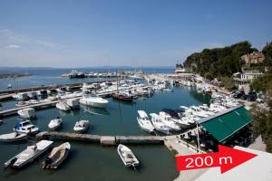 a bunch of boats are docked in a marina at Apartments Beautiful Sandy Beach in Split