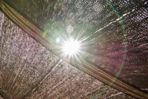 a close up of the sun shining through a curtain at Kfar Hanokdim - Glamping & Camping in Arad
