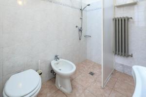 a bathroom with a toilet and a shower and a sink at Hotel Arno Bellariva in Florence