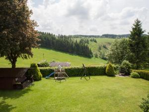 a large yard with a playground and a slide at Pension Haus Brieden in Winterberg