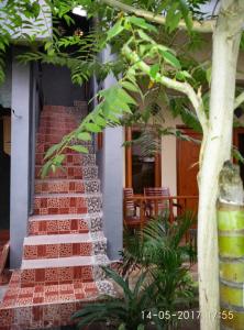 a building with a red brick staircase in a yard at Chika House in Gili Trawangan