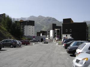 a parking lot with cars parked in front of buildings at Appartement Les Menuires in Les Menuires