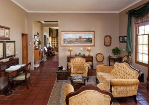 a living room with couches and chairs at La Plume Boutique Hotel & Spa in Oudtshoorn
