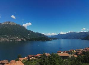 a view of a lake with houses and mountains at Ca' Eleonora in Lezzeno