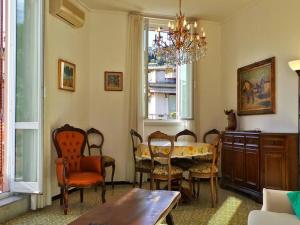 a dining room with a table and chairs and a chandelier at Dante Flexyrent Apartment in Rapallo