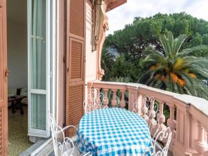 a table on the balcony of a house at Dante Flexyrent Apartment in Rapallo