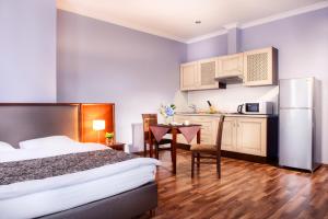 a hotel room with a bed and a kitchen at Flatlux Apartments in Kyiv