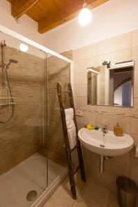 a bathroom with a shower and a sink and a shower at Dimora Nonna Rosa in Conversano