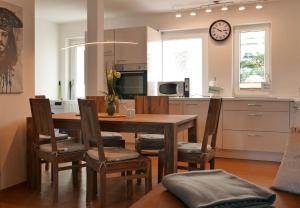 a kitchen and dining room with a wooden table and chairs at Ferienwohnung Baabe Jack Sparrow Ref. 189689-2 in Baabe