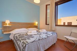 Rúm í herbergi á Residence Favignana