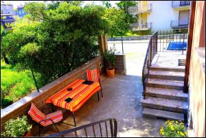 a patio with a table and two chairs and stairs at Orlando's Apartments OJ in Izola