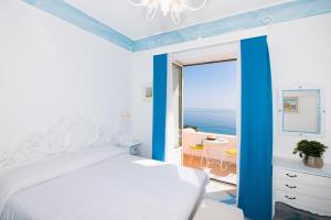 a bedroom with a bed and a view of the ocean at Villa Flavio Gioia in Positano