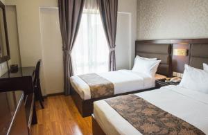 Postel nebo postele na pokoji v ubytování Castello Hotel