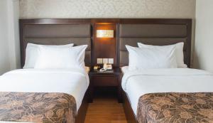Postel nebo postele na pokoji v ubytování Castello Hotel