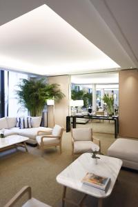 a living room with white couches and tables at Five Seas by Inwood Hotels in Cannes