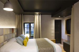 Postel nebo postele na pokoji v ubytování Hotel Le Colombier Suites