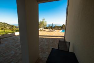 a view of a patio from a room with a window at Apartments Matanovi Dvori in Makarska