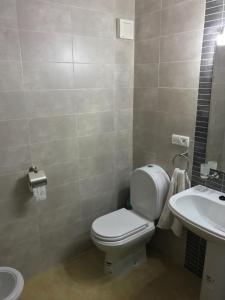 a bathroom with a toilet and a sink at Appartement Bellavista - Cabo Negro in Cabo Negro