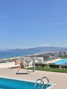 a swimming pool with a view of a city at Appartement Bellavista - Cabo Negro in Cabo Negro