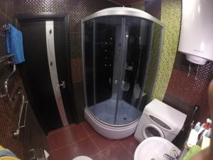 a bathroom with a shower with a toilet in it at Apartmens on Khabarovskaya in Kryvyi Rih