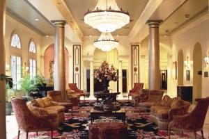 
a living room filled with couches and tables at Bourbon Orleans Hotel in New Orleans
