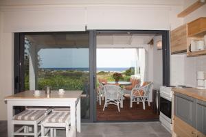 a kitchen with a sliding glass door leading to a patio at Artemis Village Apartments & Studios in Stavros