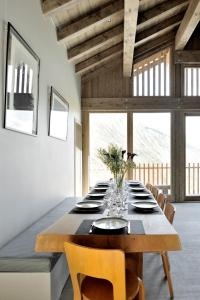 a large dining room with a long table and chairs at Home by U - Chalet 2 in Saint-Martin-de-Belleville