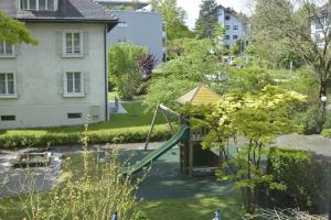 a playground in a yard with a slide at Home by Livingdowntown in Zug