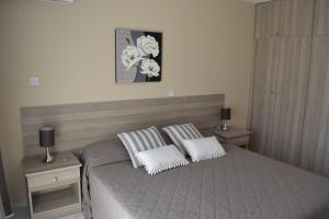 a bedroom with a bed with two pillows on it at Marianna Hotel Apartments in Limassol
