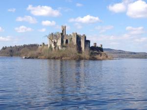 a castle on an island in the middle of a lake at Carrickamore Cottage in Boyle