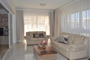 a living room with two couches and a coffee table at Marianna Hotel Apartments in Limassol