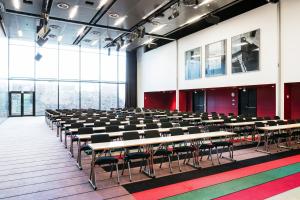 an empty room with rows of tables and chairs at Quality Hotel 33 in Oslo