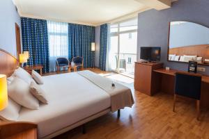 Hotel Delfín客房内的一张或多张床位