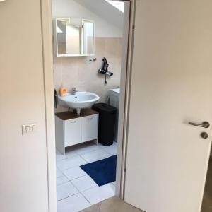 a bathroom with a white sink and a mirror at Apartment Patrizia in Zadar +27 photos