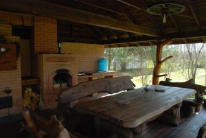 a wooden table in a room with a brick oven at Peipsi rannamaja in Nina