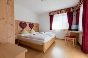 Postel nebo postele na pokoji v ubytování Pension Garden Hotel