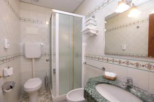 a bathroom with a toilet and a sink and a shower at Hotel Mega Mare in Vico Equense