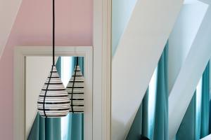 a mirror with two black and white vases at Hotel Haussmann Saint Augustin in Paris