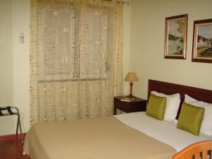 En eller flere senge i et værelse på Hotel Santa Barbara