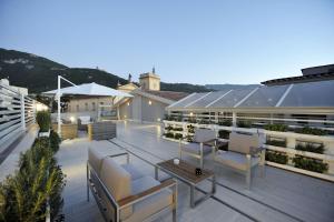 eine Dachterrasse mit Stühlen und einem Tisch in der Unterkunft Luxury Apartment Della Marca in SantʼAntonio Abate