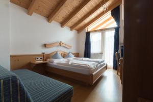 Postel nebo postele na pokoji v ubytování Pension Garden Hotel