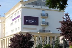 a large white building with a sign on it at Hôtel Mercure Marne-la-Vallée Bussy St Georges in Bussy-Saint-Georges
