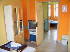 a room with orange walls and a room with a tv at Yo Ho Hostel in Varna City